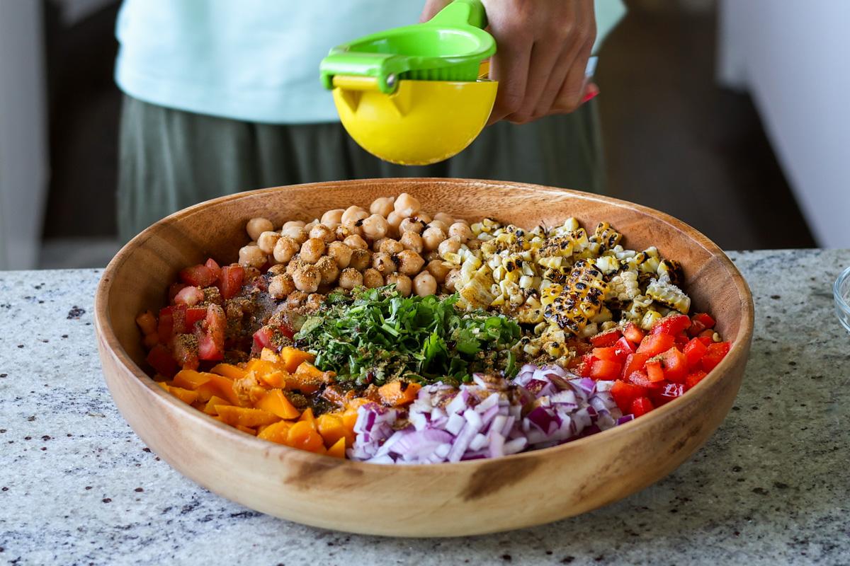 adding lime juice to the mango chickpea salad