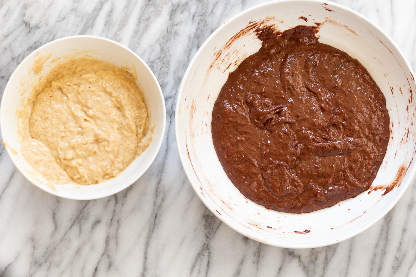 dark and bright banana bread batter in two bowl ready to be combined for making marbled loaf