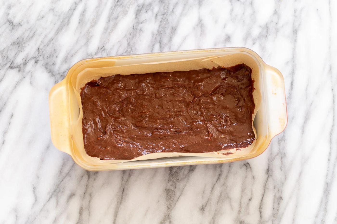 overhead shot of a loaf pan with unbaked vegan chocolate banana bread