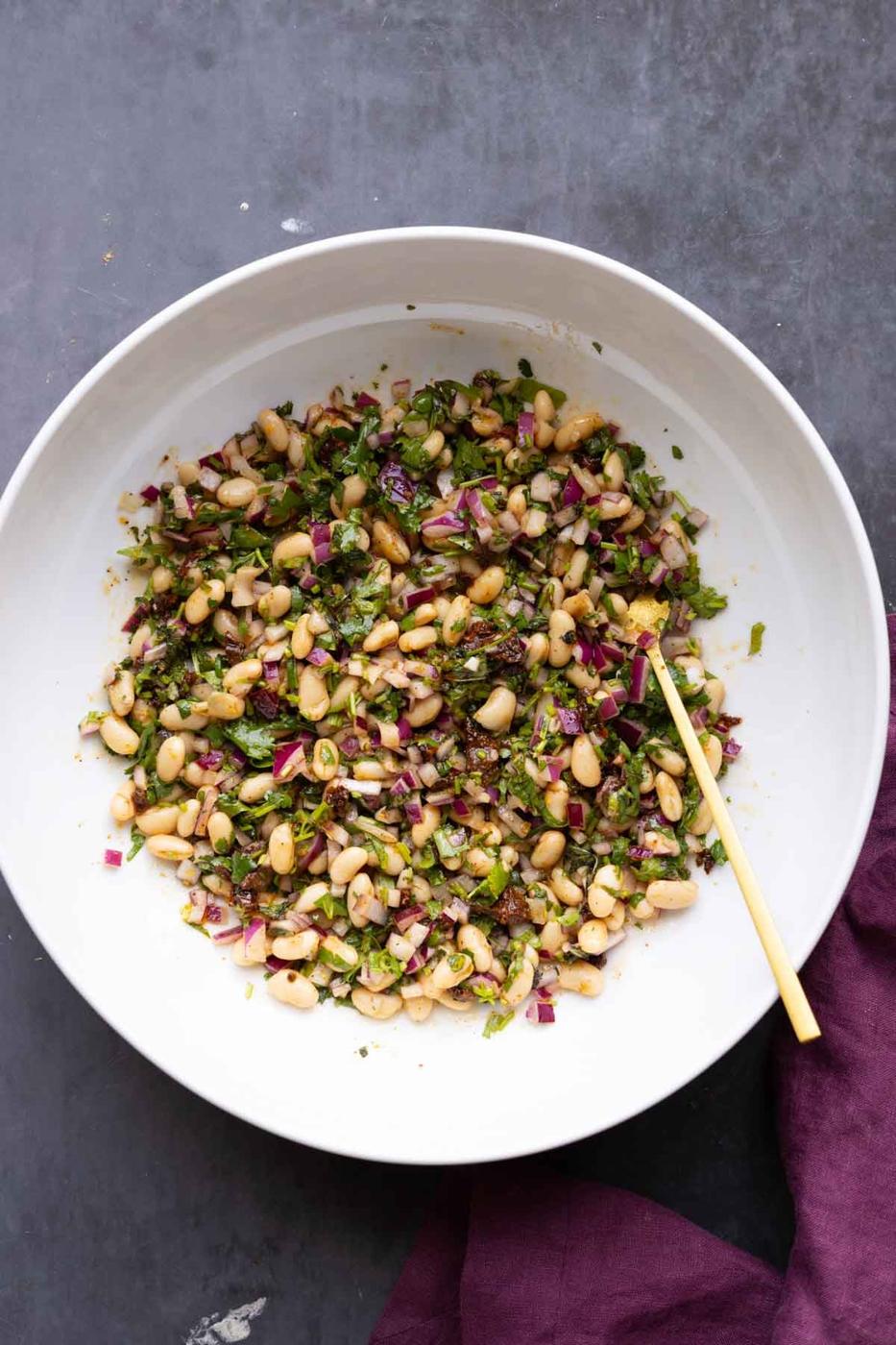 white bean salad after mixing with the dressing