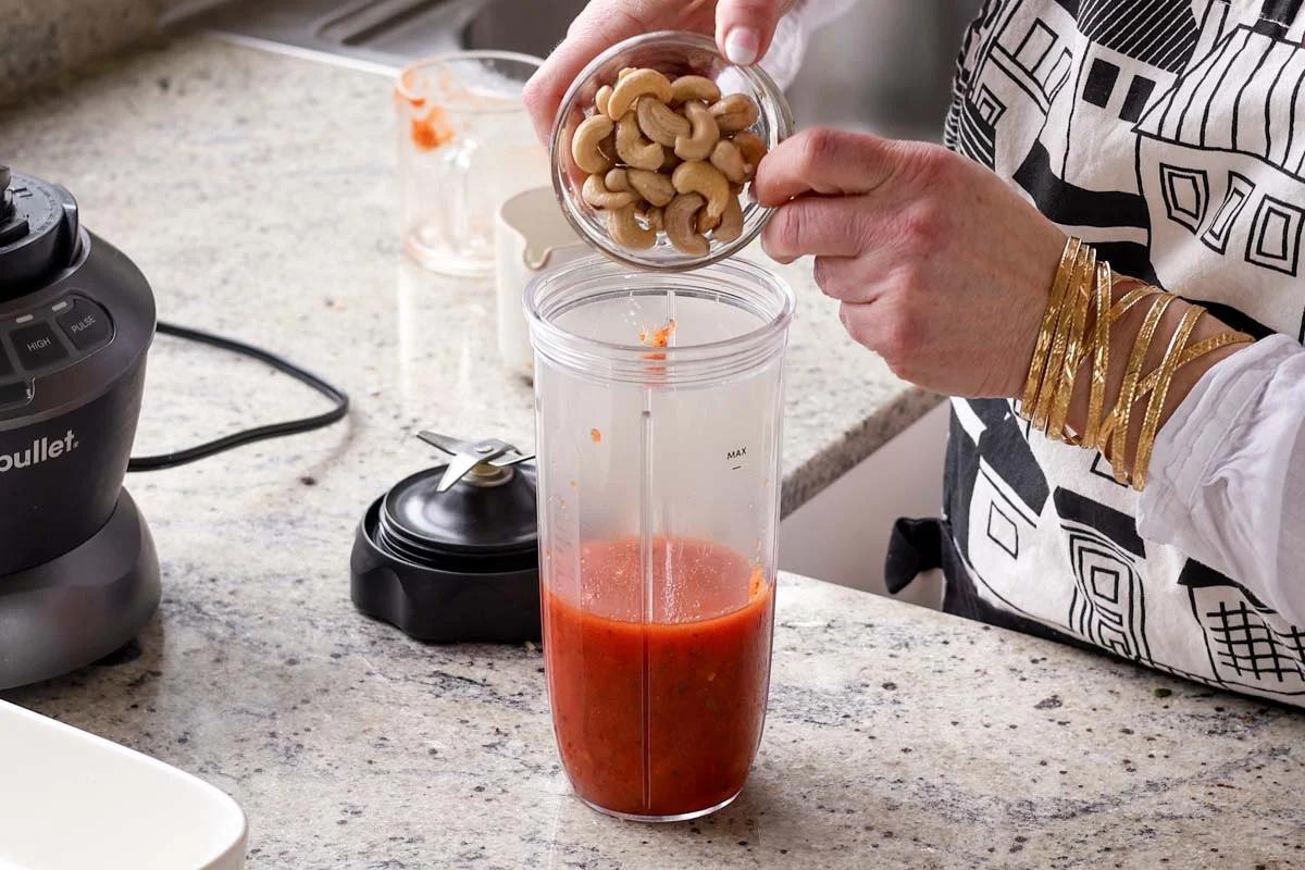 adding sauce ingredients to the blender