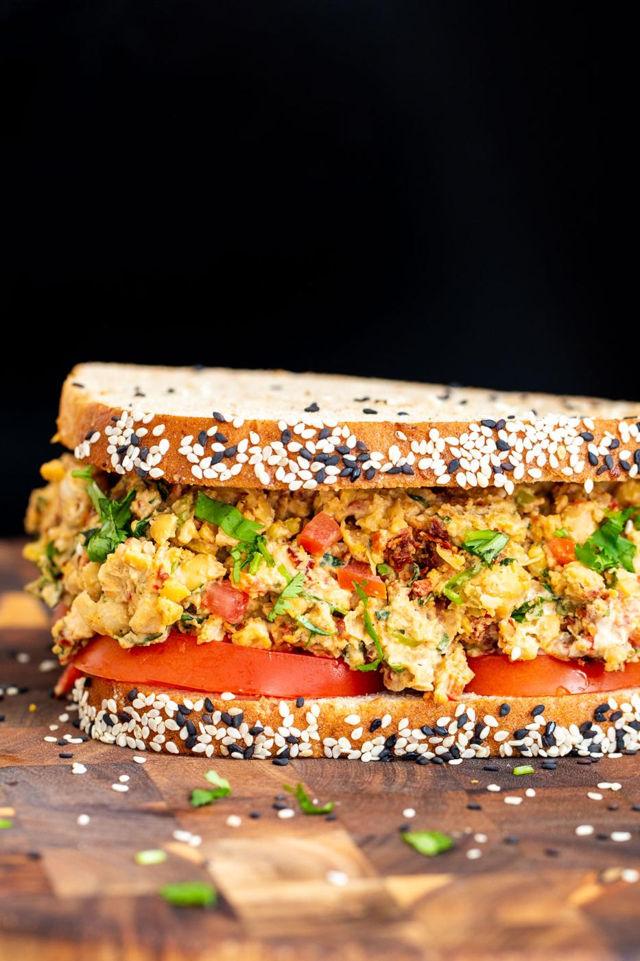 close up side view of vegan Mediterranean chickpea sandwich