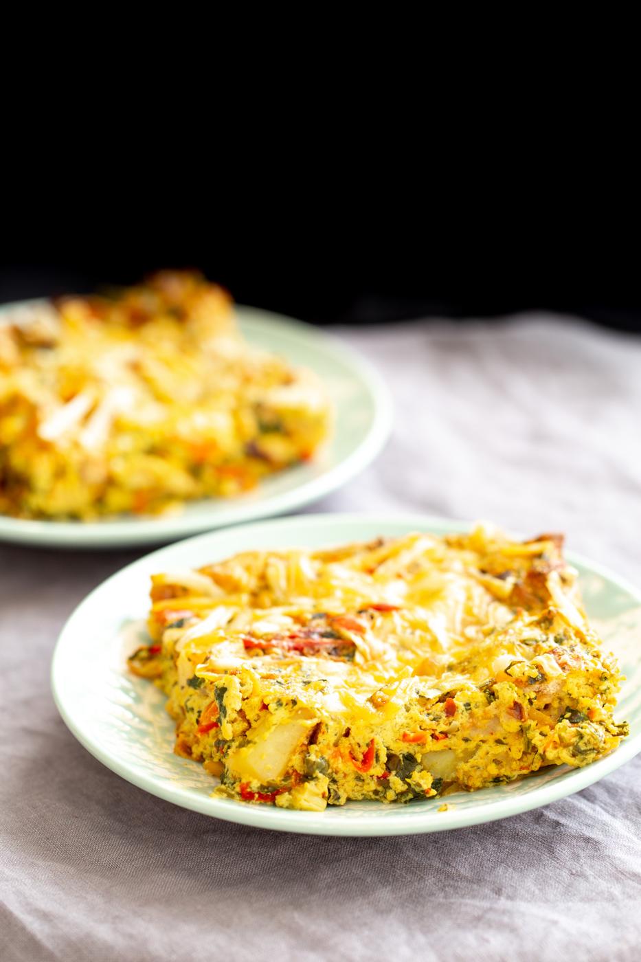 a plate with Mexican egg casserole topped with shredded cheese