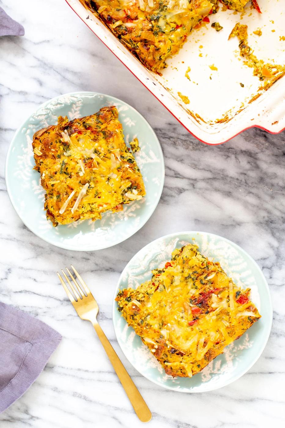 overhead shot with two plates with vegan Mexican egg breakfast casserole topped with cheese
