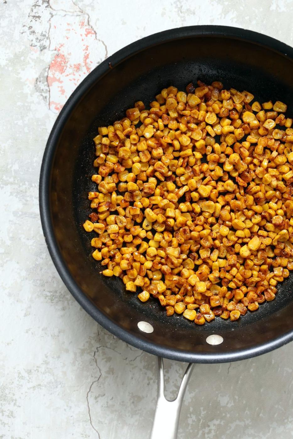 Roasted Corn for our Mexican Street Corn Sala, in a Black Skillet kept over concrete
