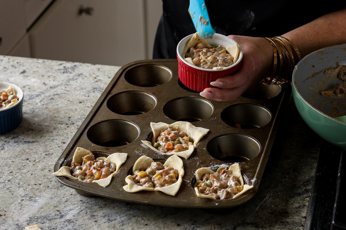 filling puff pastries in the ramekin