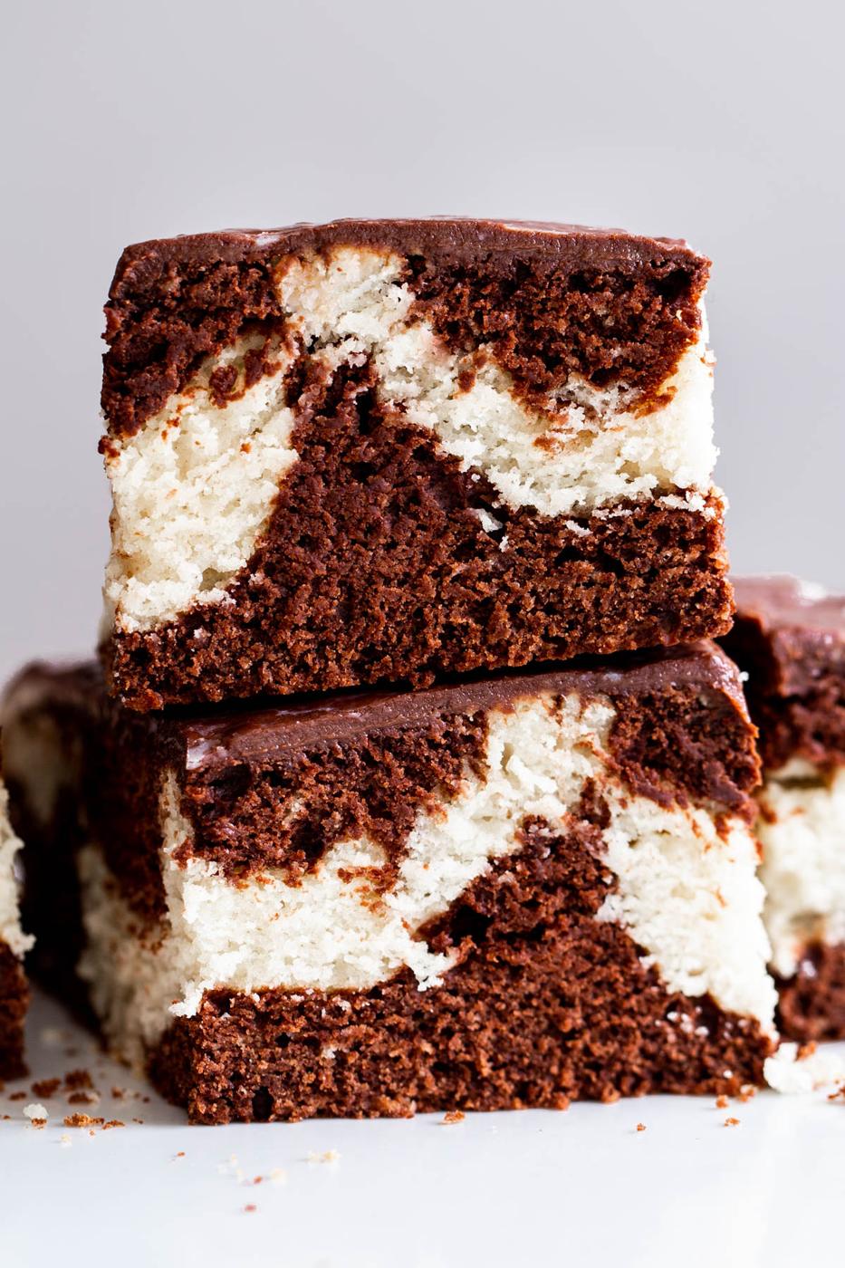 two stacked slices of vegan marble cake with chocolate ganache