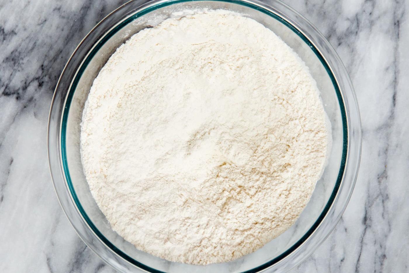 mixed dry cake batter ingredients in a glass bowl