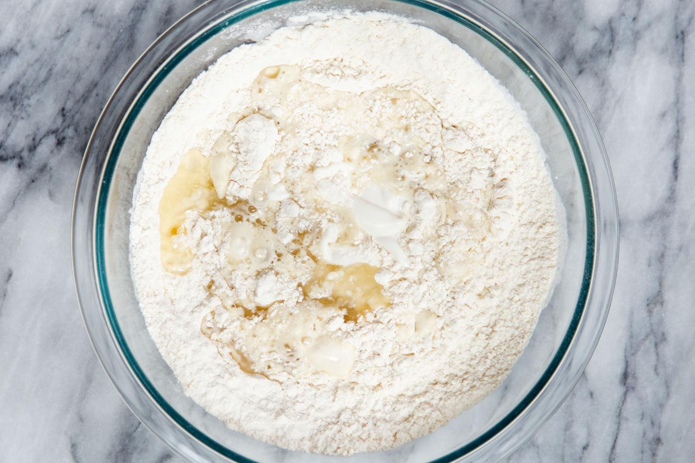 dry cake batter ingredients being mixed with wet ingredients to make cake batter