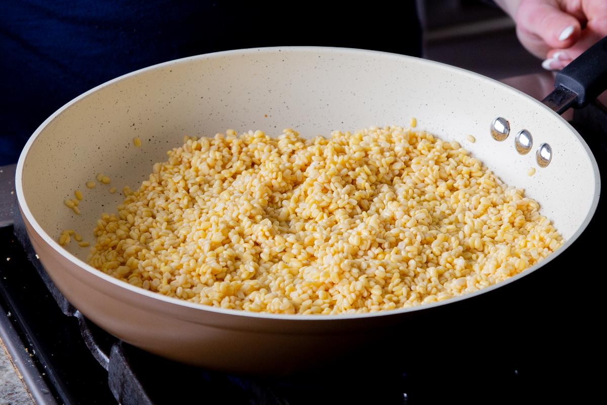 toasting the soaked moong dal in a frying pan