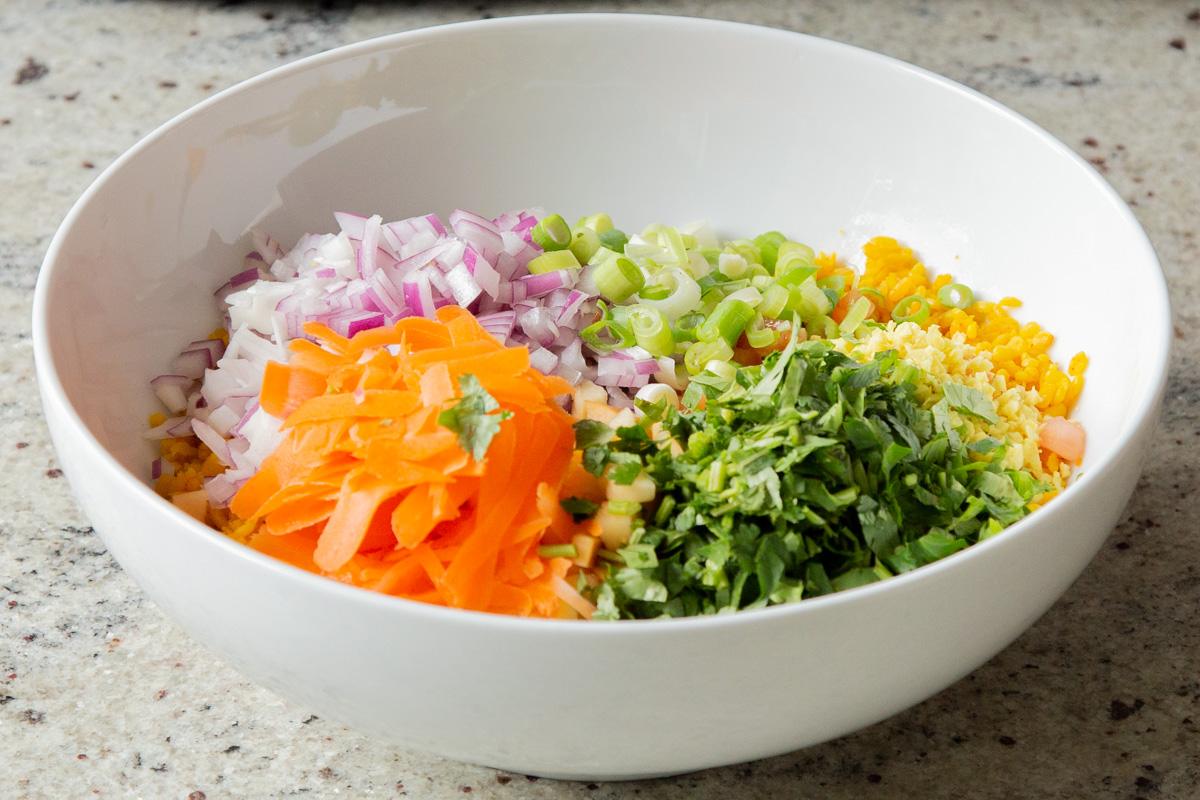 adding veggies and fresh herbs to the moong dal