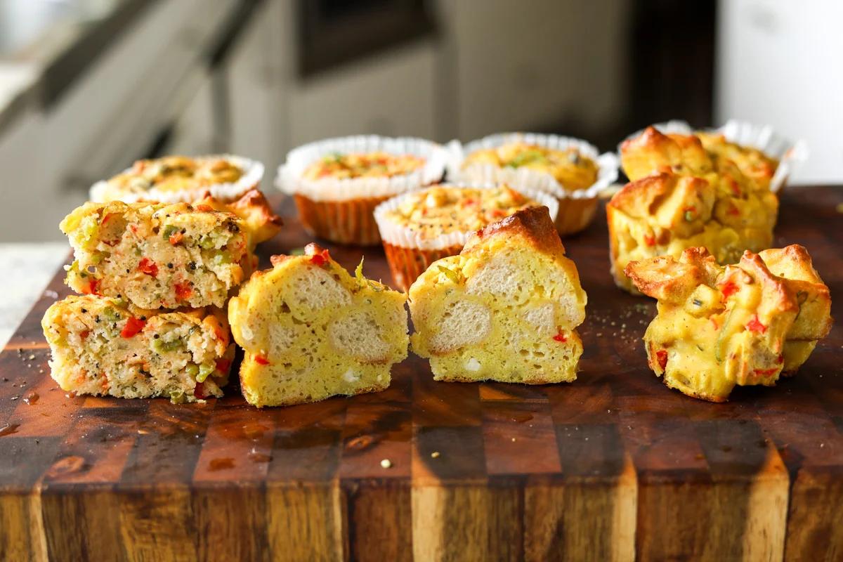 moong egg muffins on the cutting board with one cut in half, so you can see the inside
