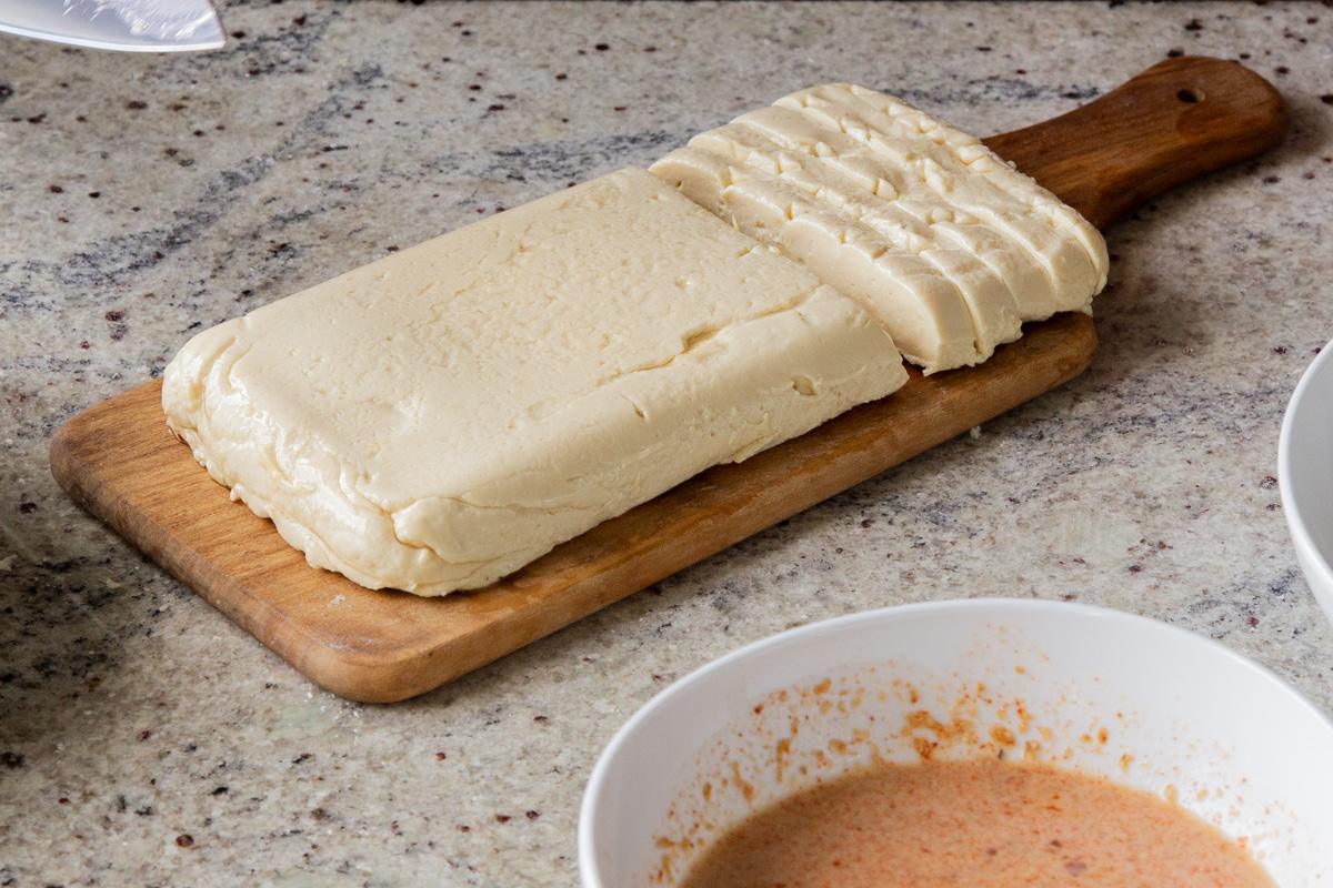 slicing the vegan mozzarella into sticks