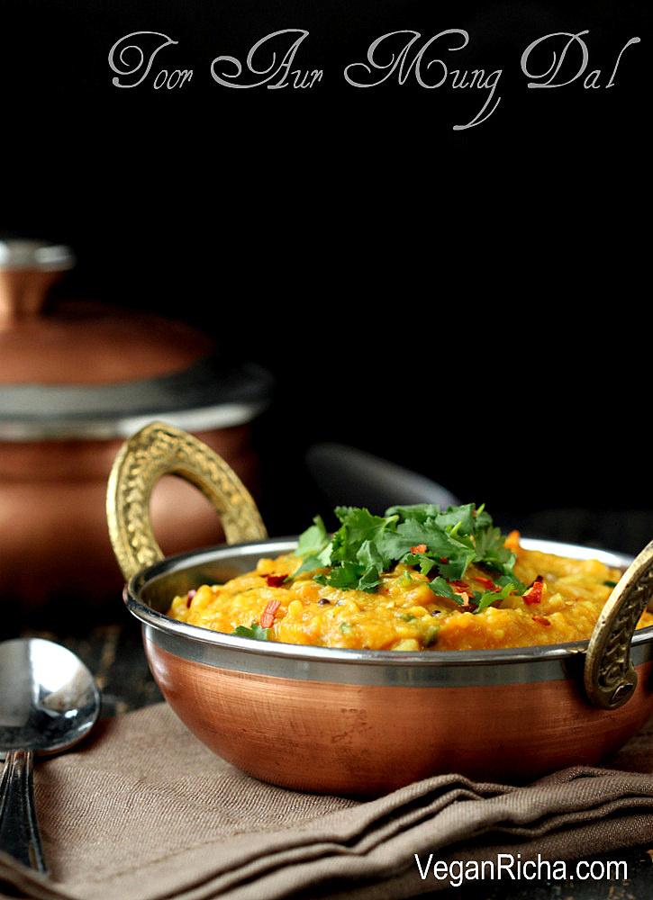 side view of a bowl with vegan Indian Mung Dal topped with chopped herbs and crushed red pepper