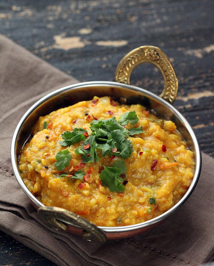 an Indian serving bowl filled with Mung Dal Split Pea Soup