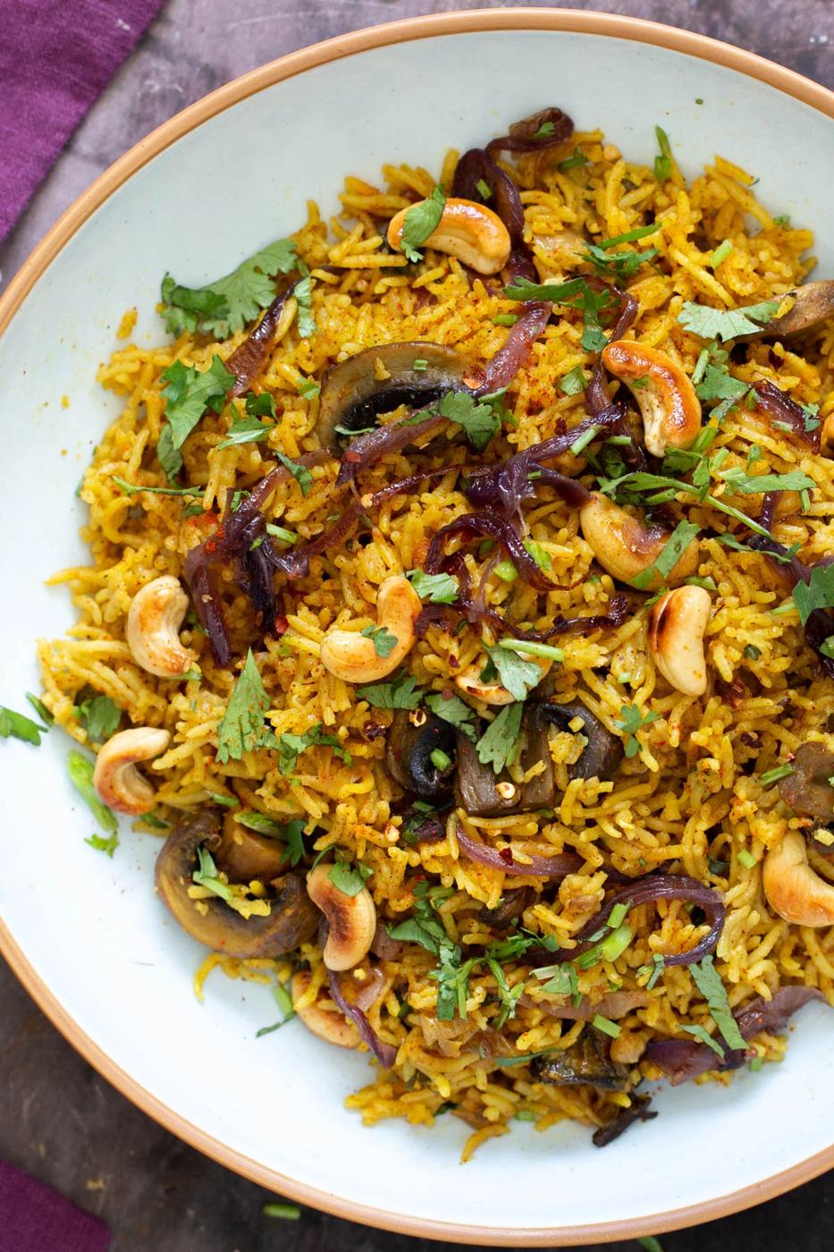 vegan mushroom rice topped with cashews and chopped cilantro