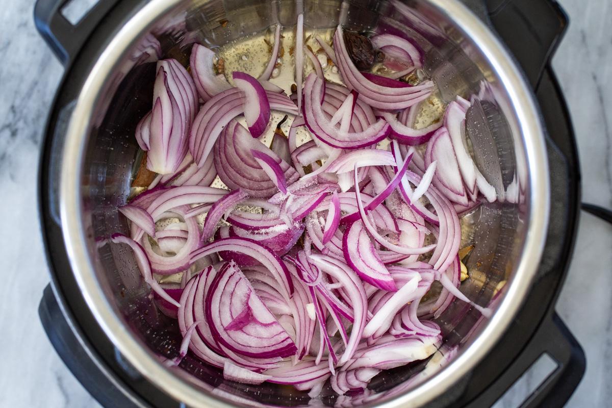 sliced onions sauteeing in an Instant Pot