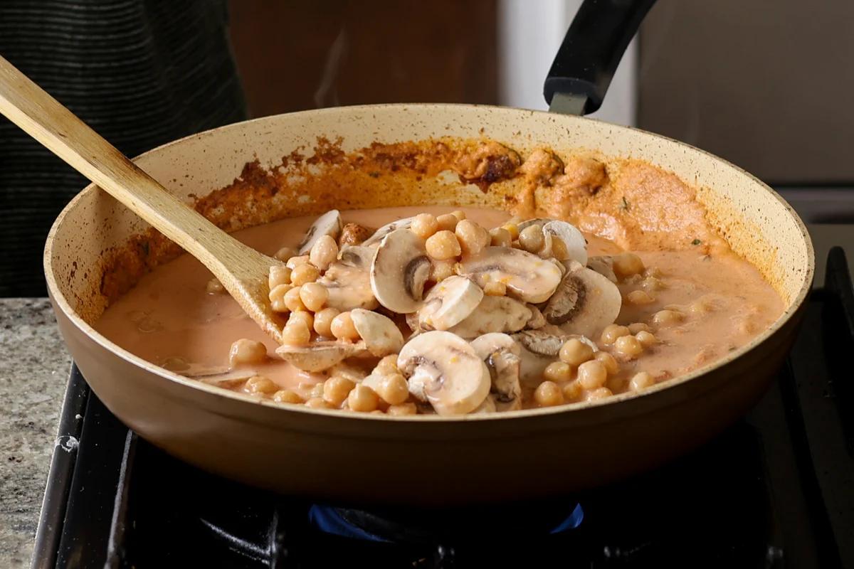 adding chickpeas to the pan