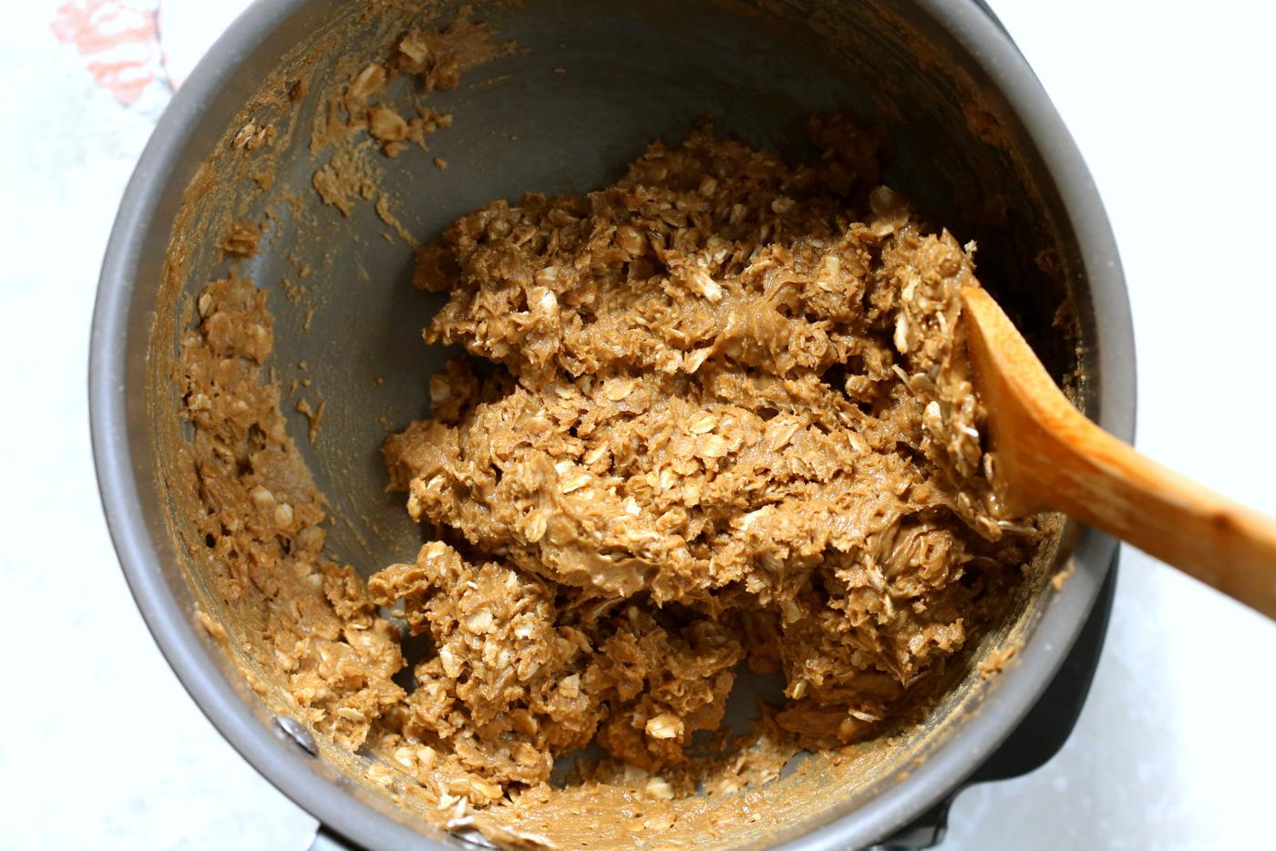Oats mixed in the sunbutter mixture in a saucepan for our Sunbutter Granola Bars