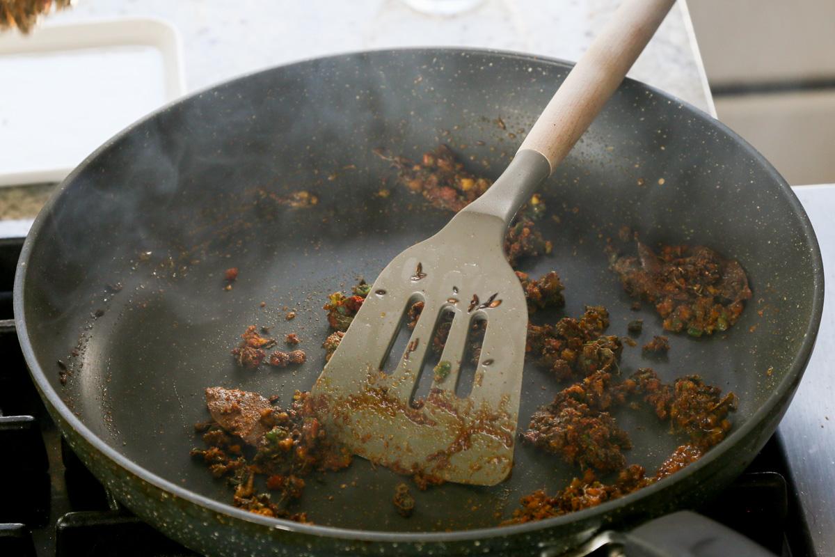mixing the ground spices and aromatics