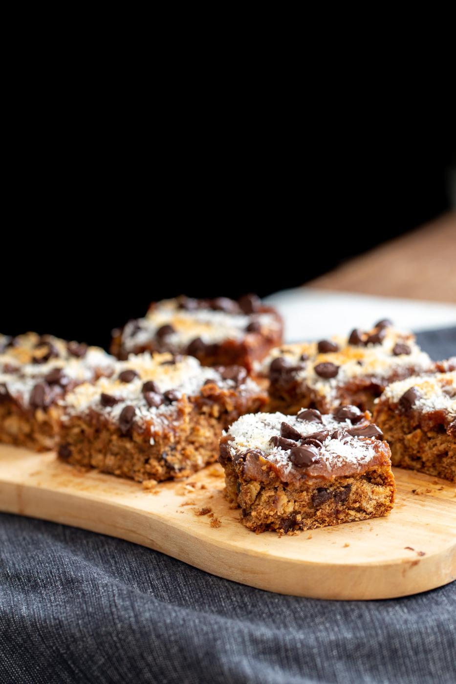 vegan oatmeal date caramel bars on a wooden board
