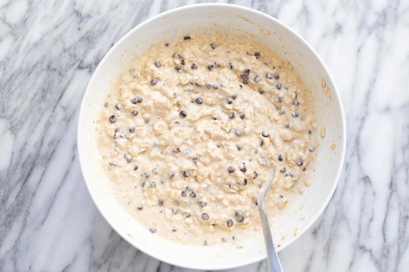 overhead shot of a white bowl with vegan chocolate chip waffle batter
