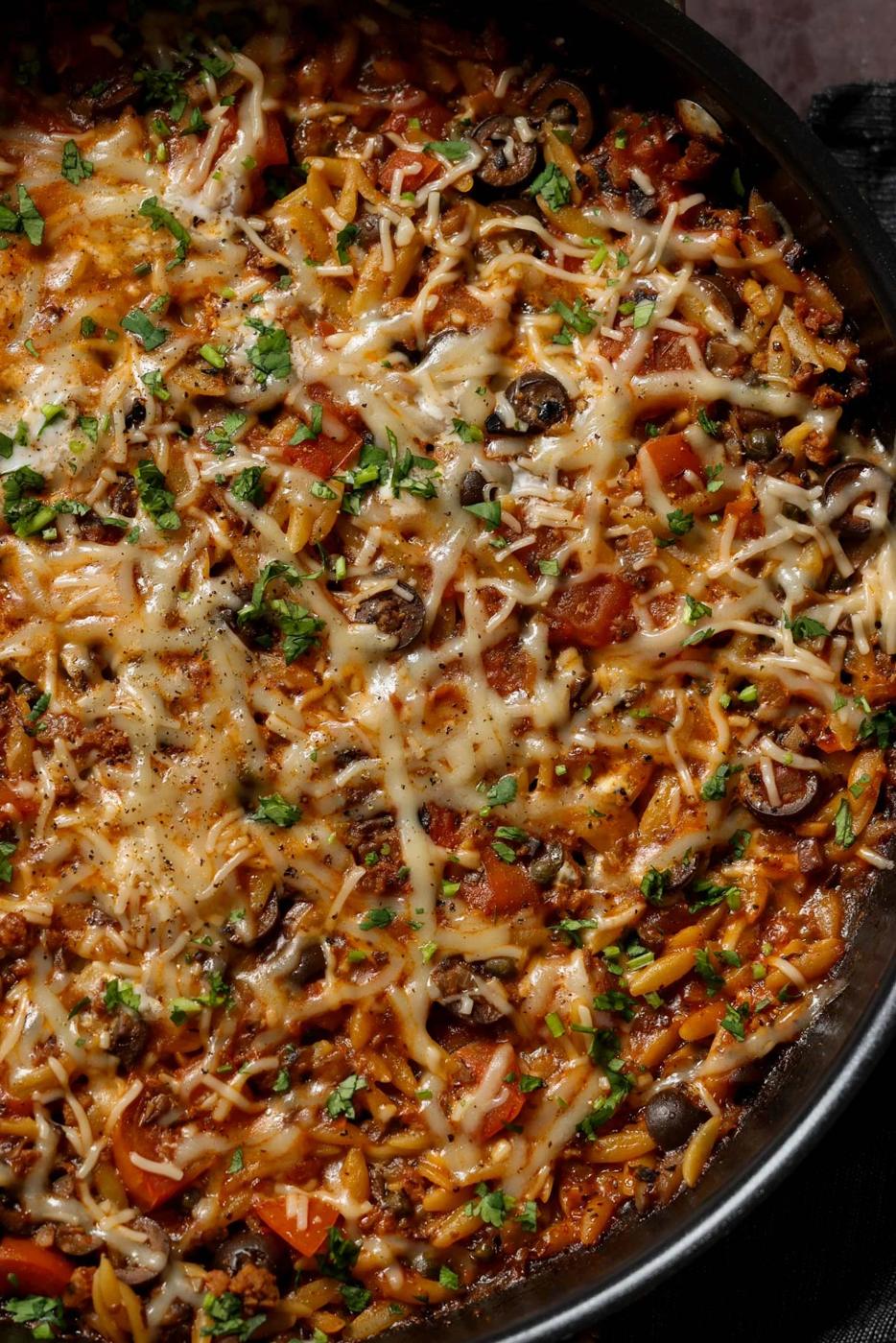 close-up of orzo puttanesca in the pan
