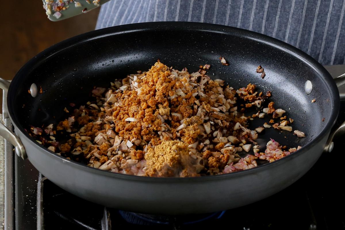 adding veggie crumbles to the pan