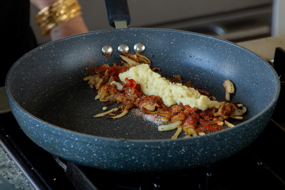adding ginger-garlic paste to the onions