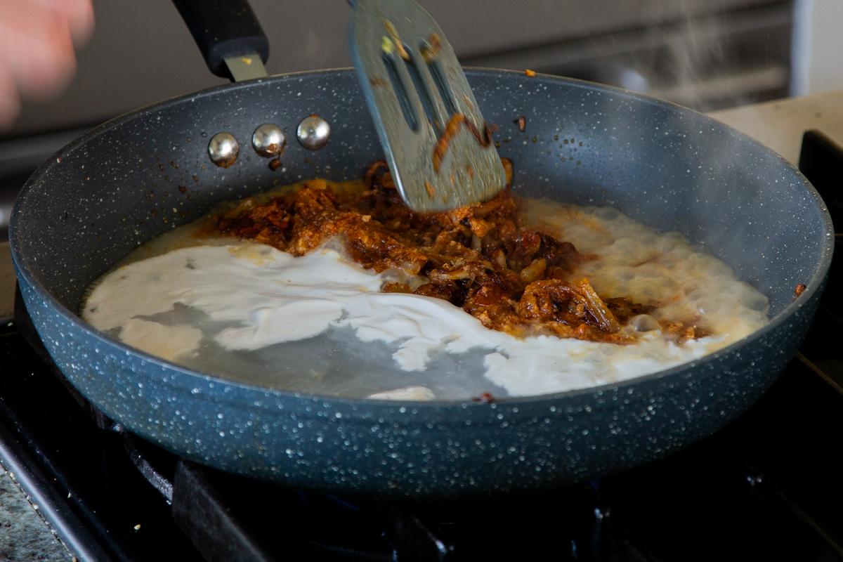 adding non-dairy yogurt to the onion mixture