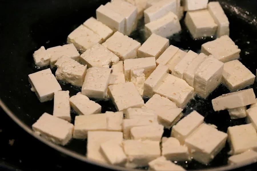 Tofu getting panfried in a skillet for our Vegan Palak tofu Paneer
