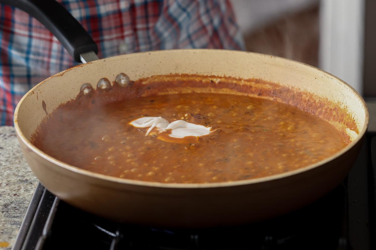 adding more non-dairy yogurt to the sauce