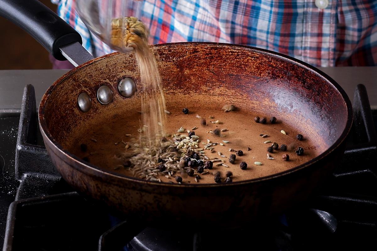 adding whole spices to the pan