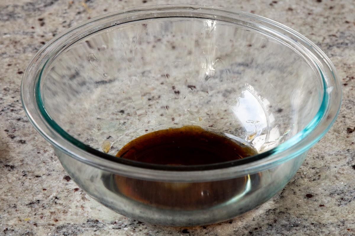 oil, vanilla, and maple syrup mixed together in a small glass bowl
