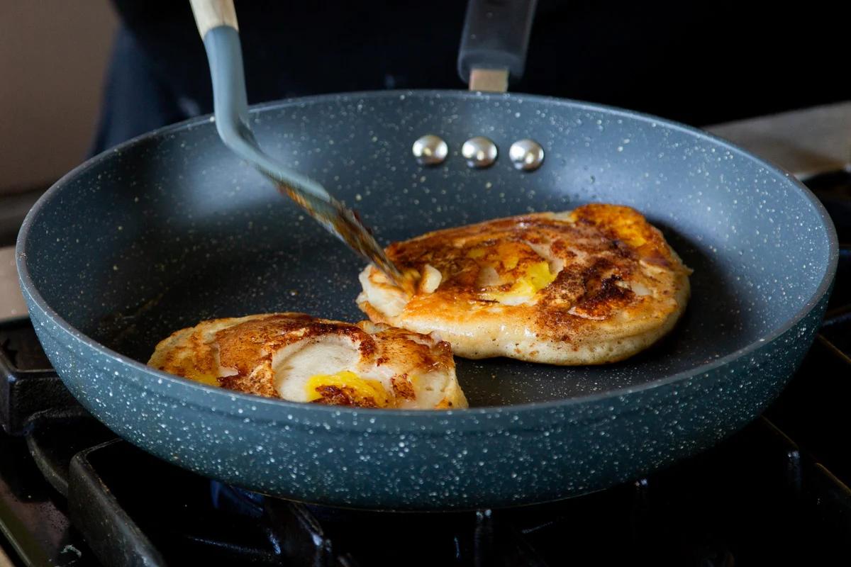 peach pancakes in the pan, peach-side-up
