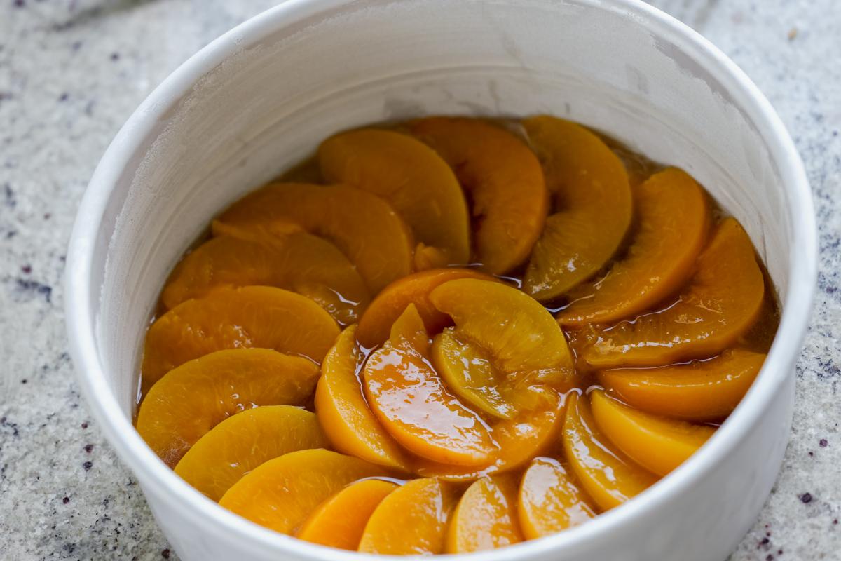 peaches layered into the bottom of the cake pan