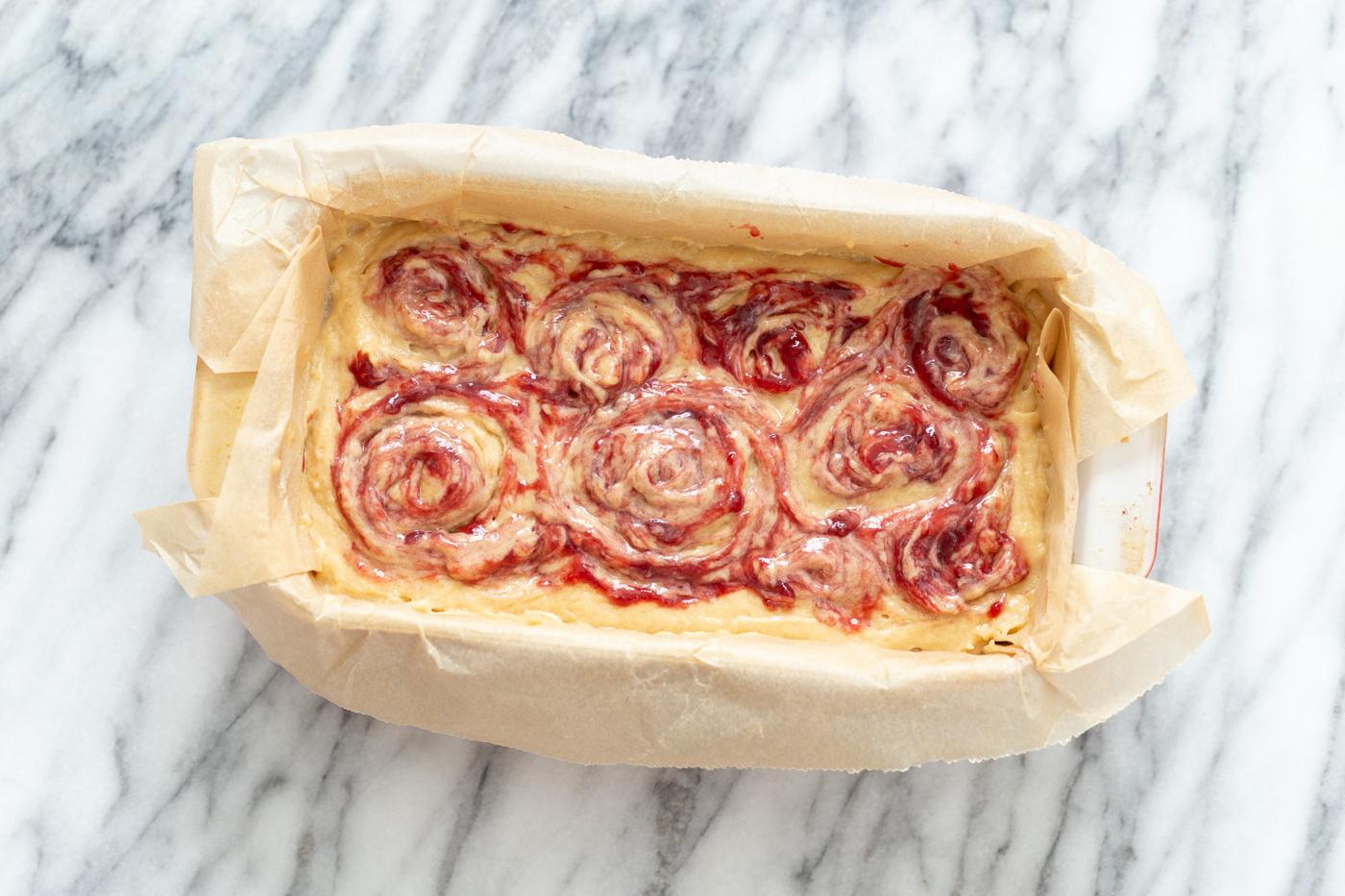 vegan peanut butter and jelly cake in a loaf pan ready to be baked