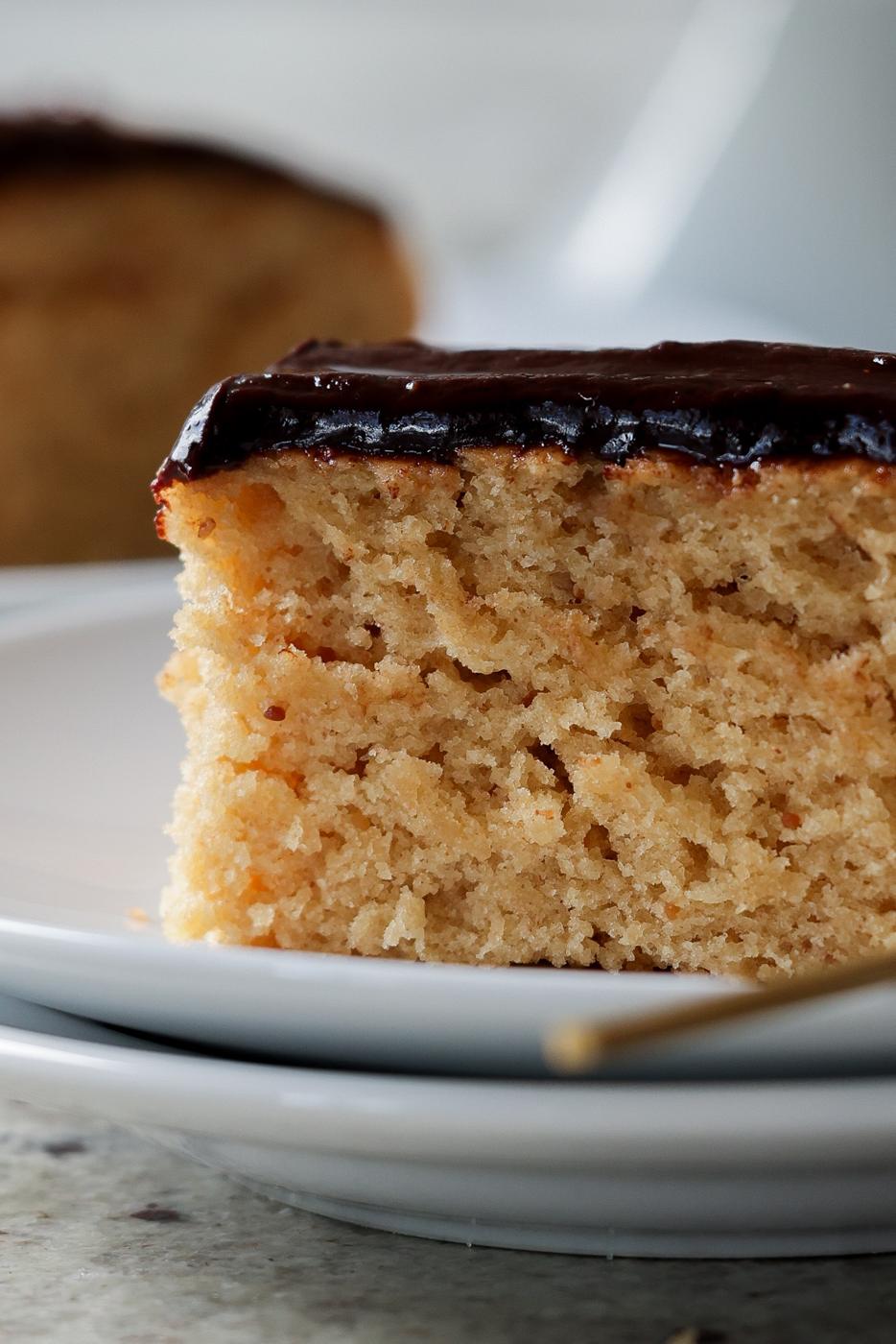 close-up of slice of peanut butter cake with chocolate peanut butter glaze