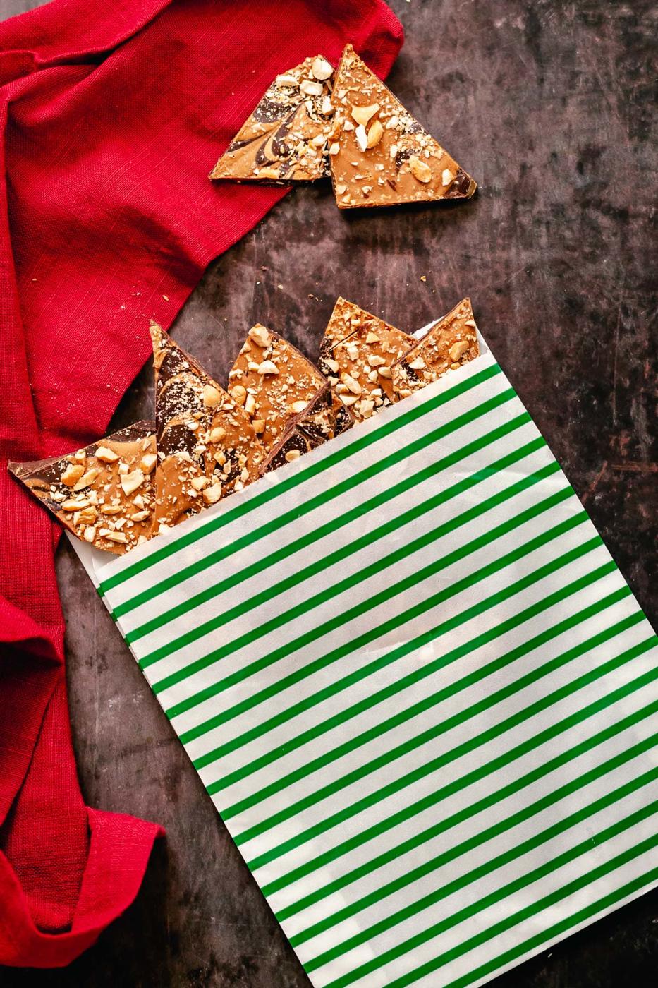 vegan peanut butter cup chocolate bark in a small paper bag