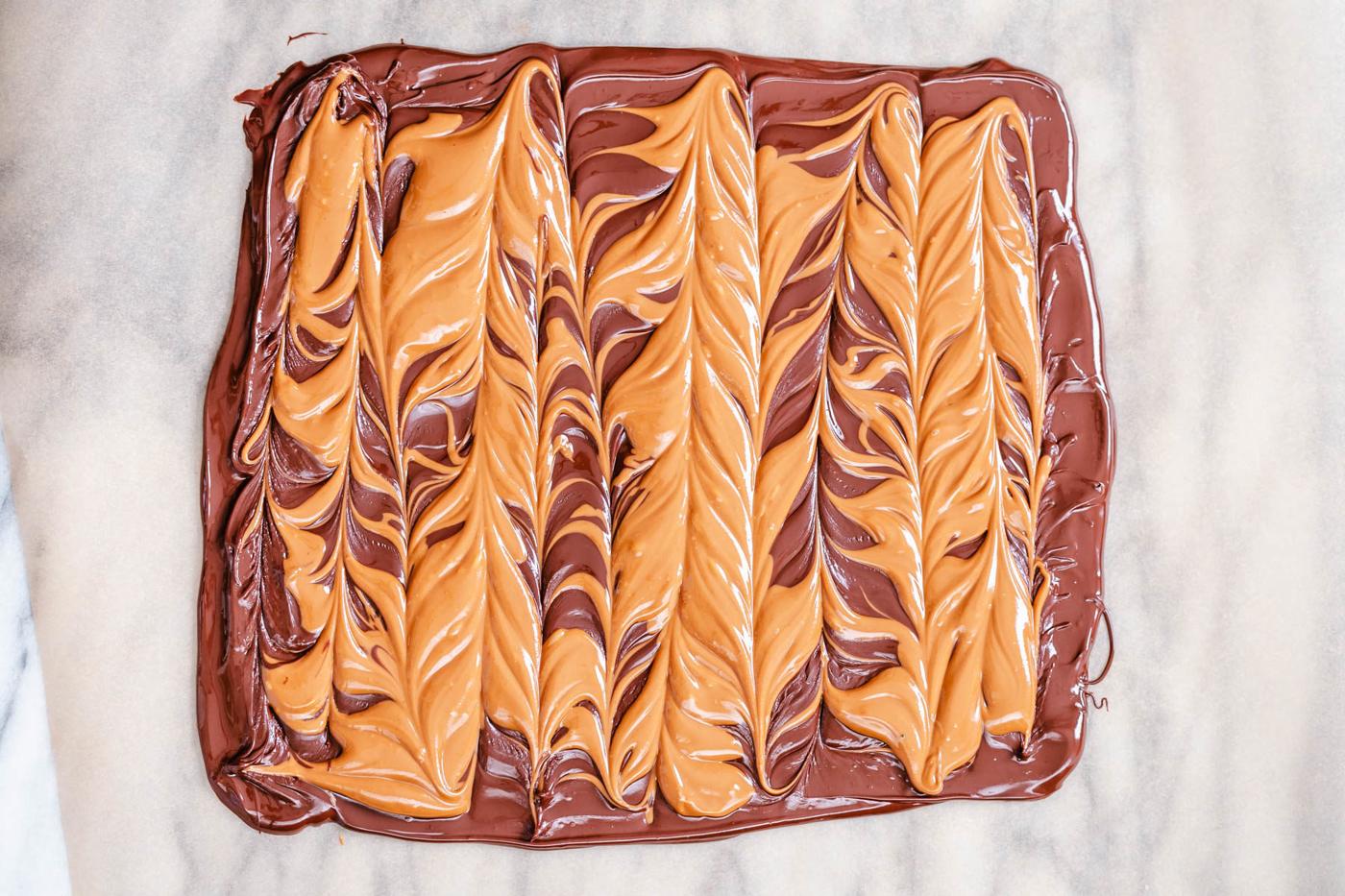 peanut butter cup chocolate bark on a sheet of parchment paper