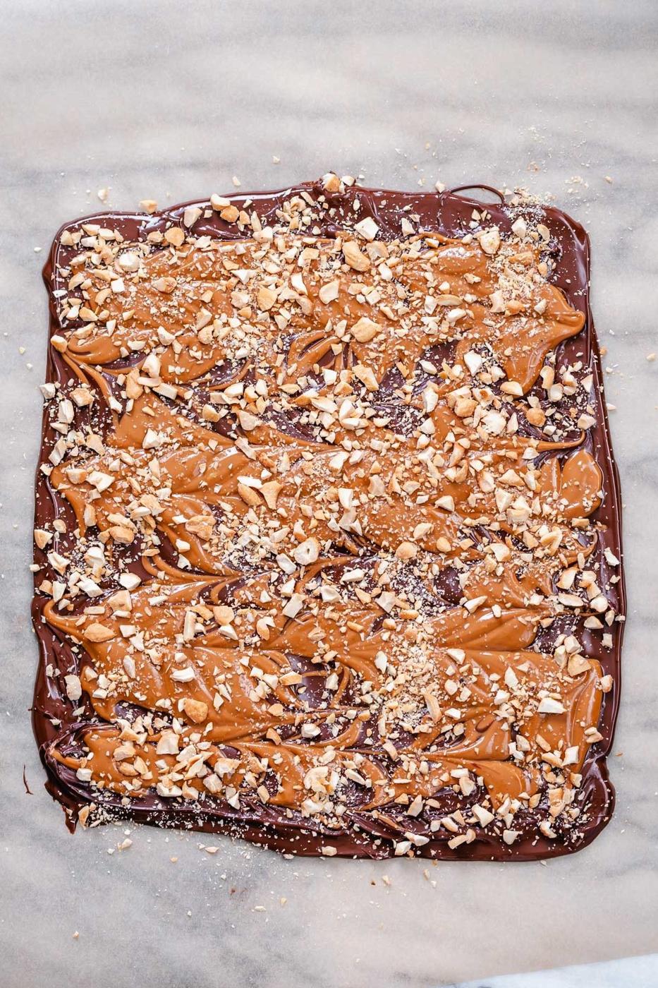 overhead shot of set vegan peanut butter cup chocolate bark sprinkled with peanuts