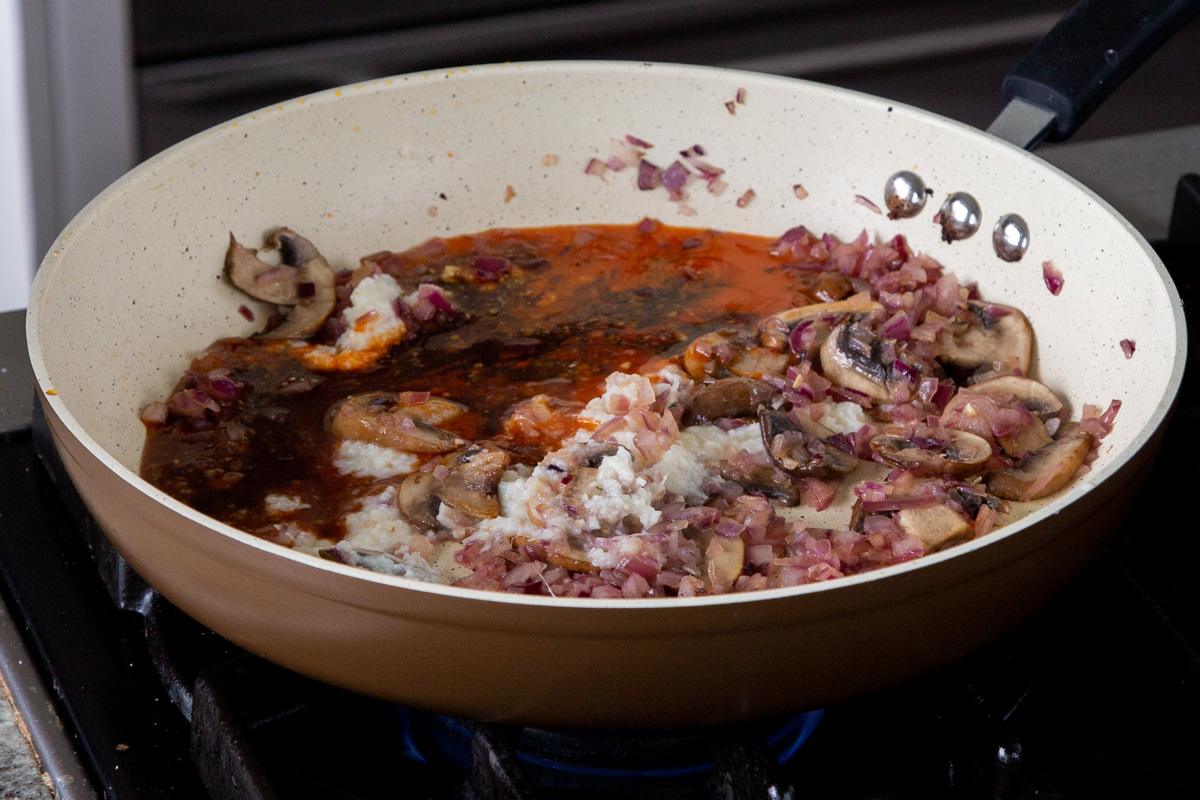 adding sauces to the pan with the ginger garlic paste