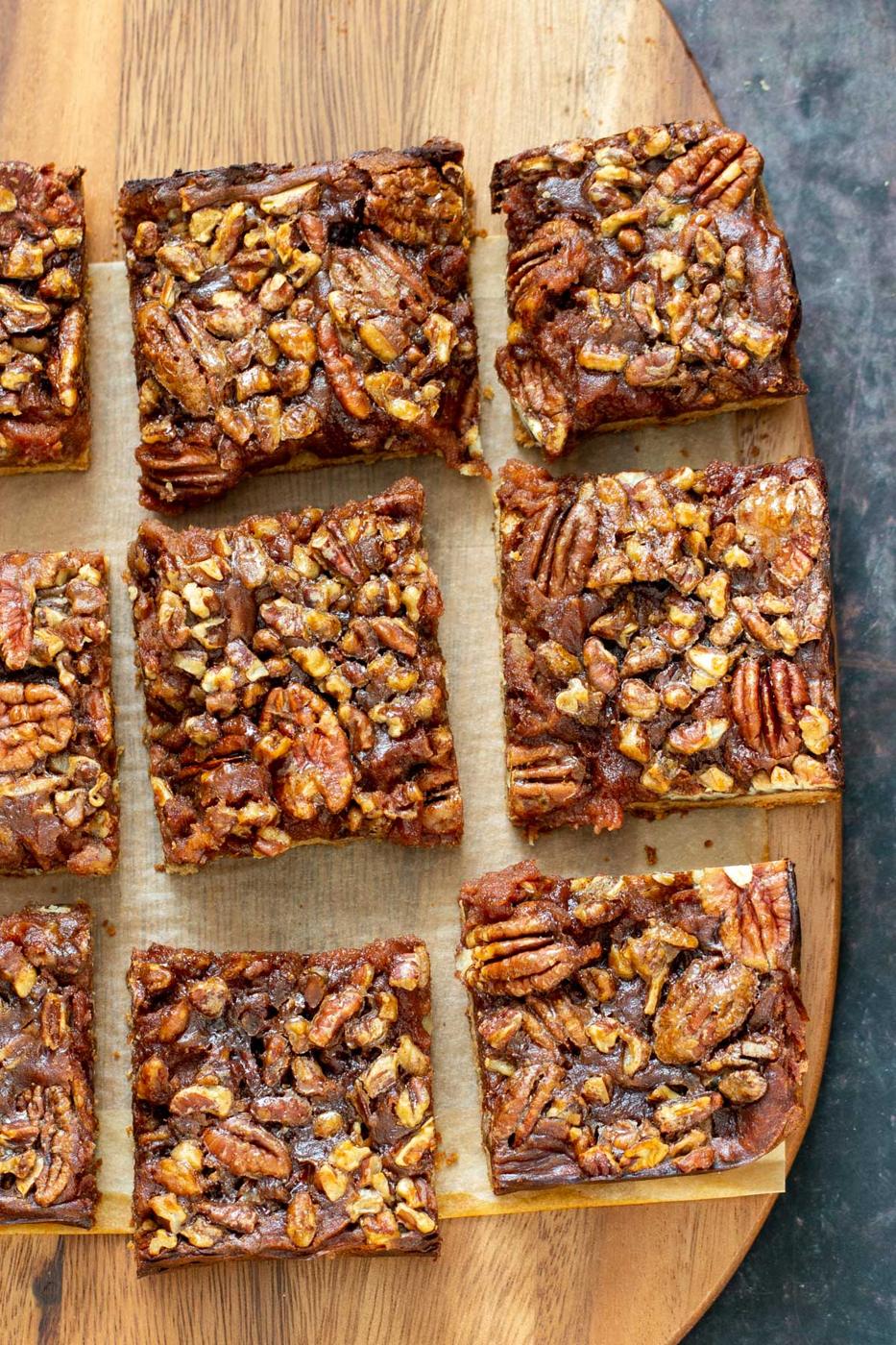 vegan pecan pie bars on a wooden board