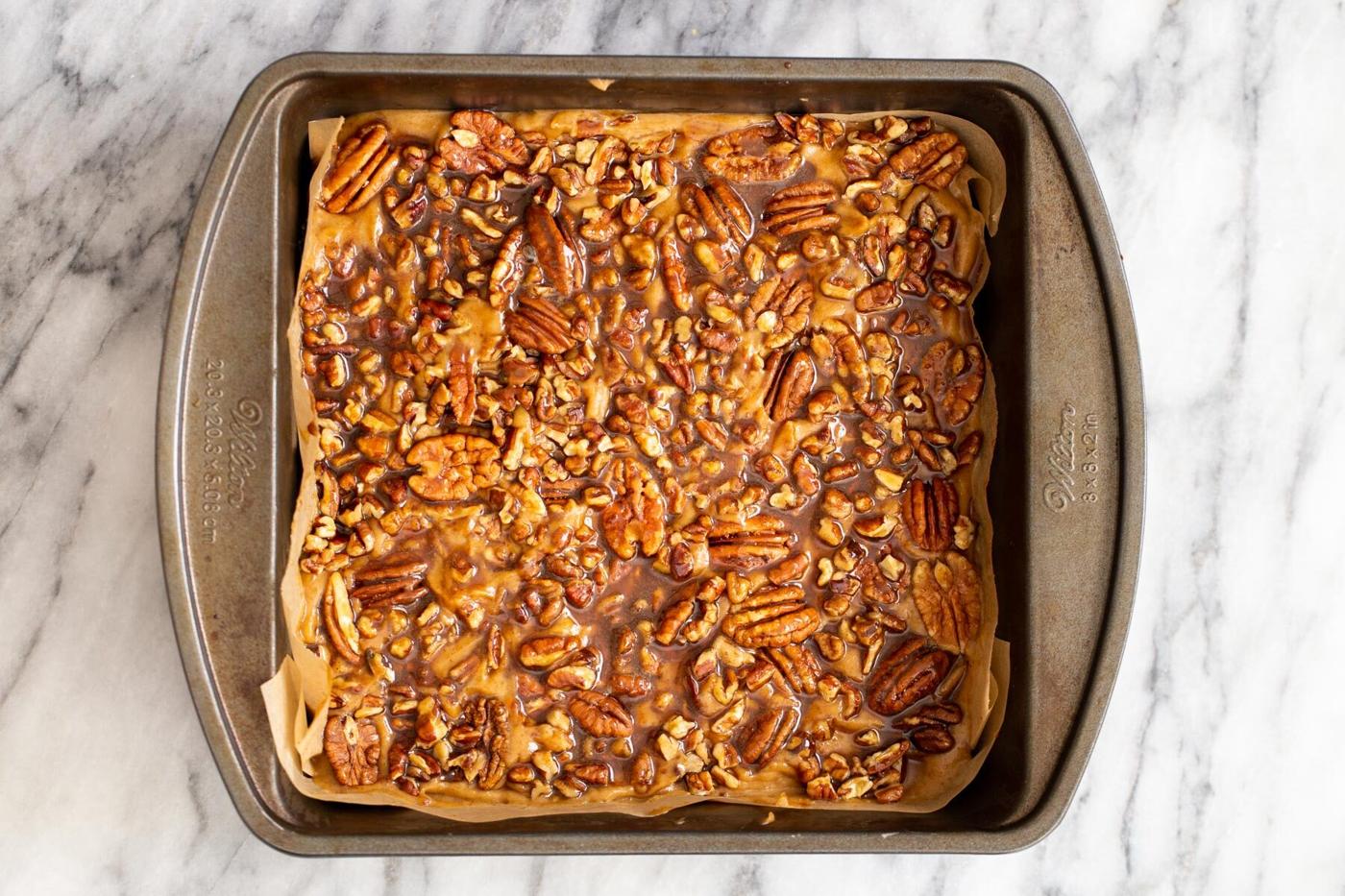 shortcrust pastry topped with pecans and maple syrup