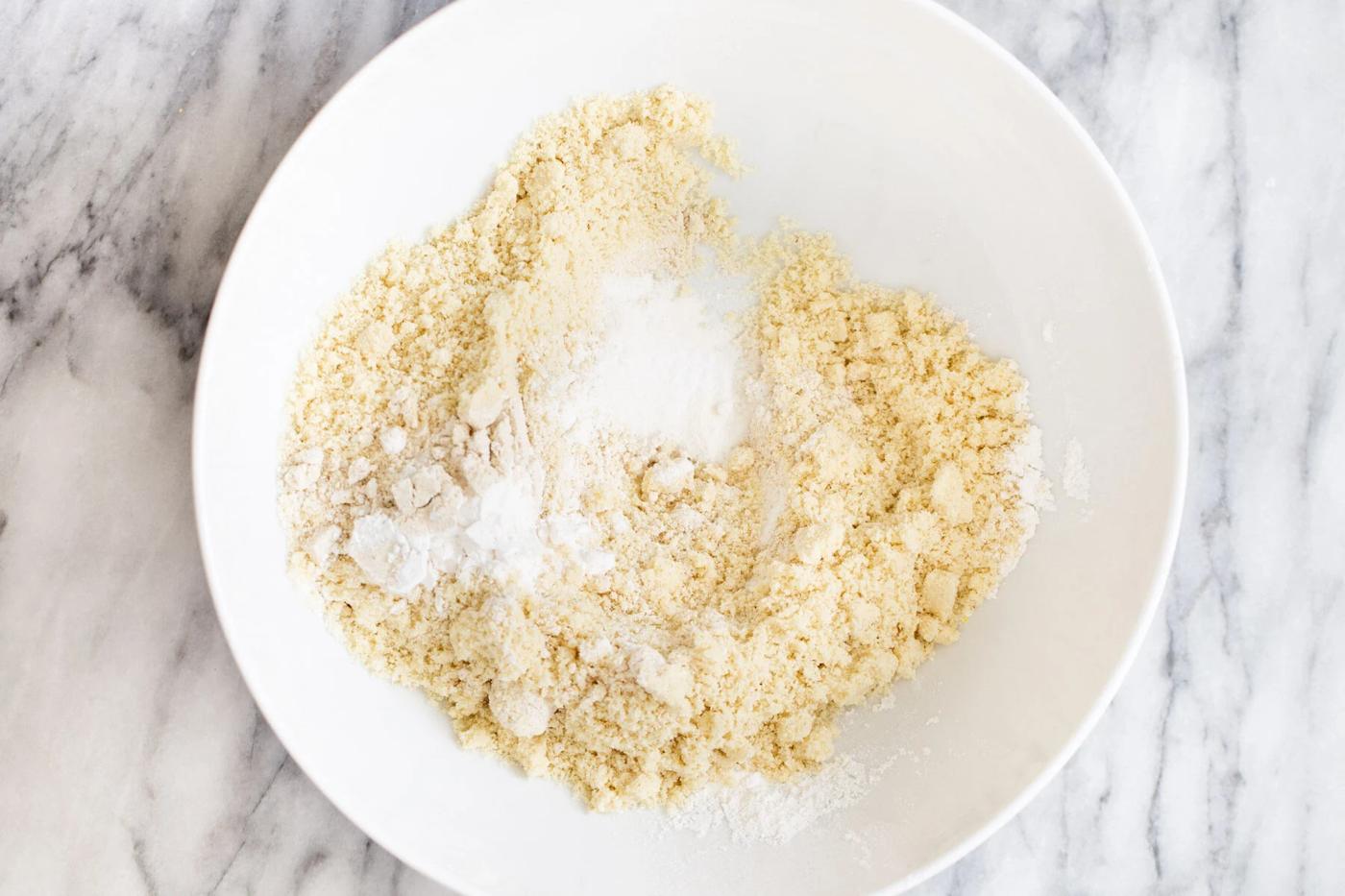 dry mix for vegan pecan pie bars in a white bowl