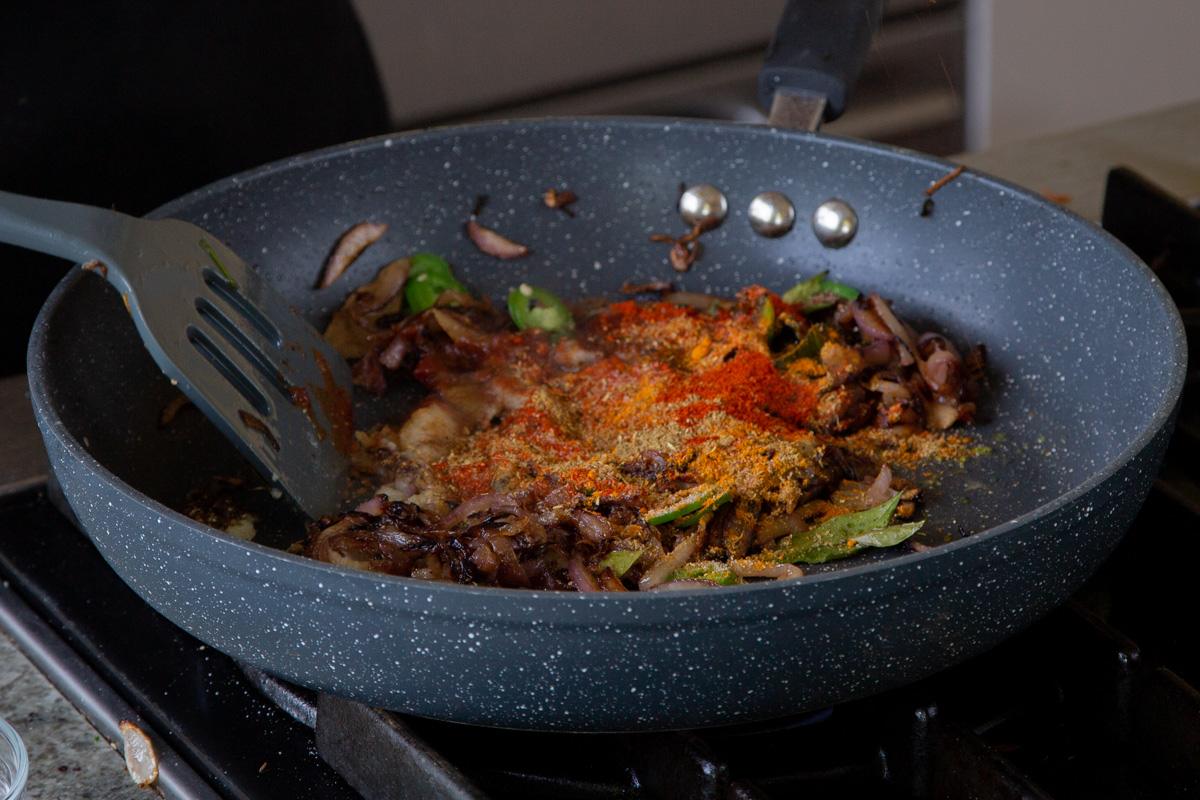 adding ground spices to the onion mixture