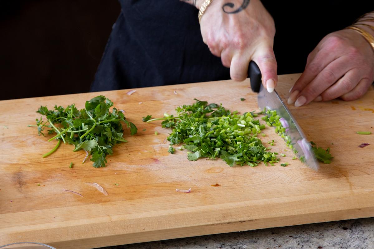 chopping cilantro and green chilis