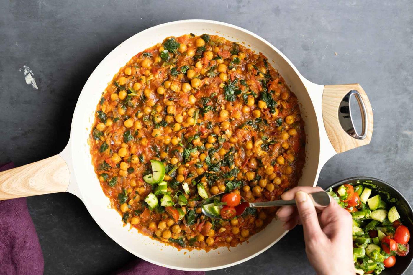 adding the salsa to the peri-peri chickpeas in the pan after cooking