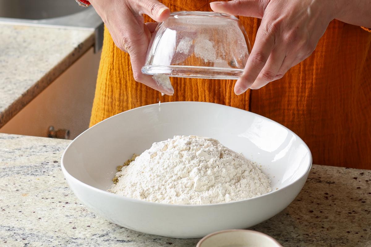 adding dry ingredients to the bowl