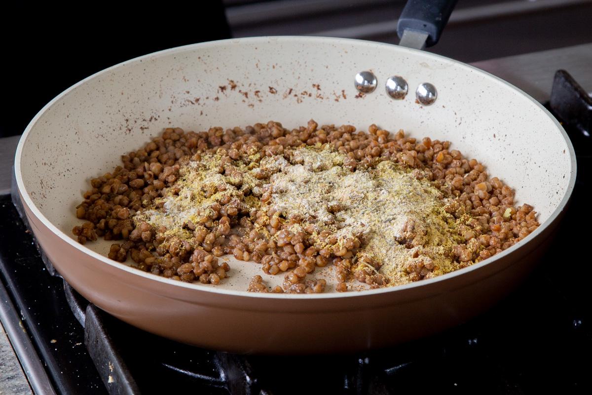 adding spices to the popped lentils
